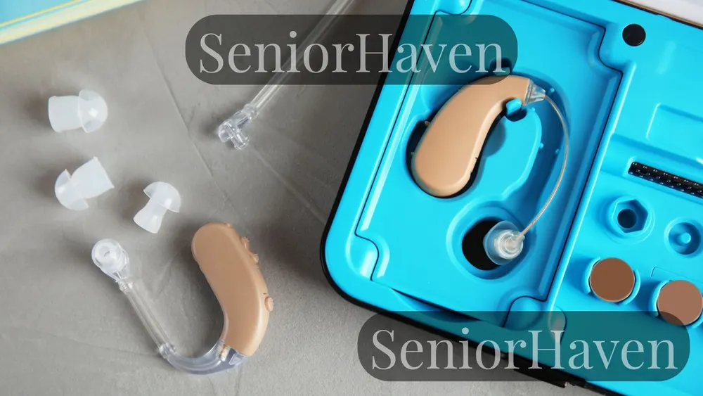 Behind-the-ear hearing aids, ear tips, and an open case on a grey table, top view
