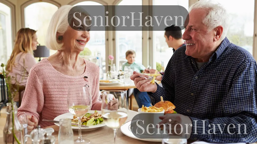 A senior couple talking over a meal in a busy restaurant, with other diners behind them