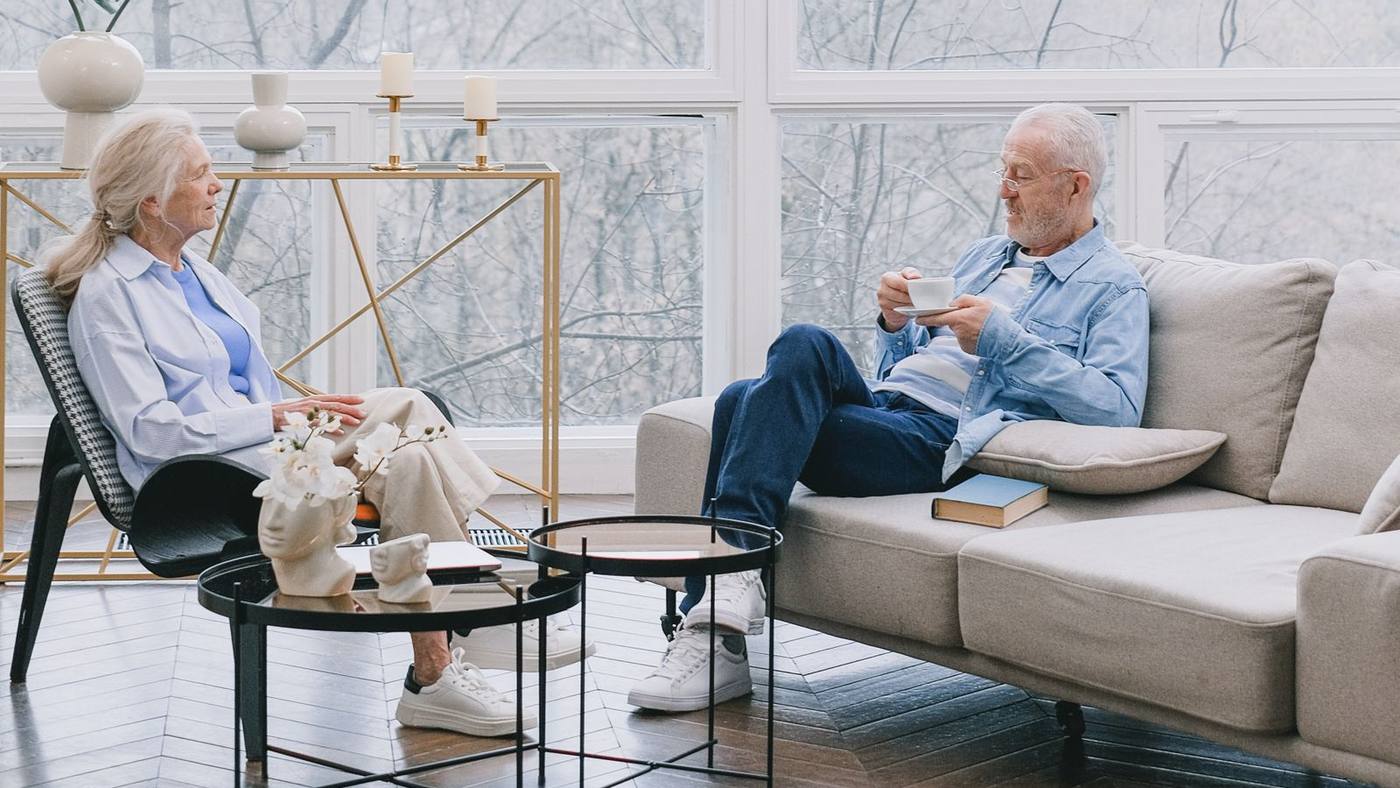 A senior couple at home, smiling — the people this deal hub is built for