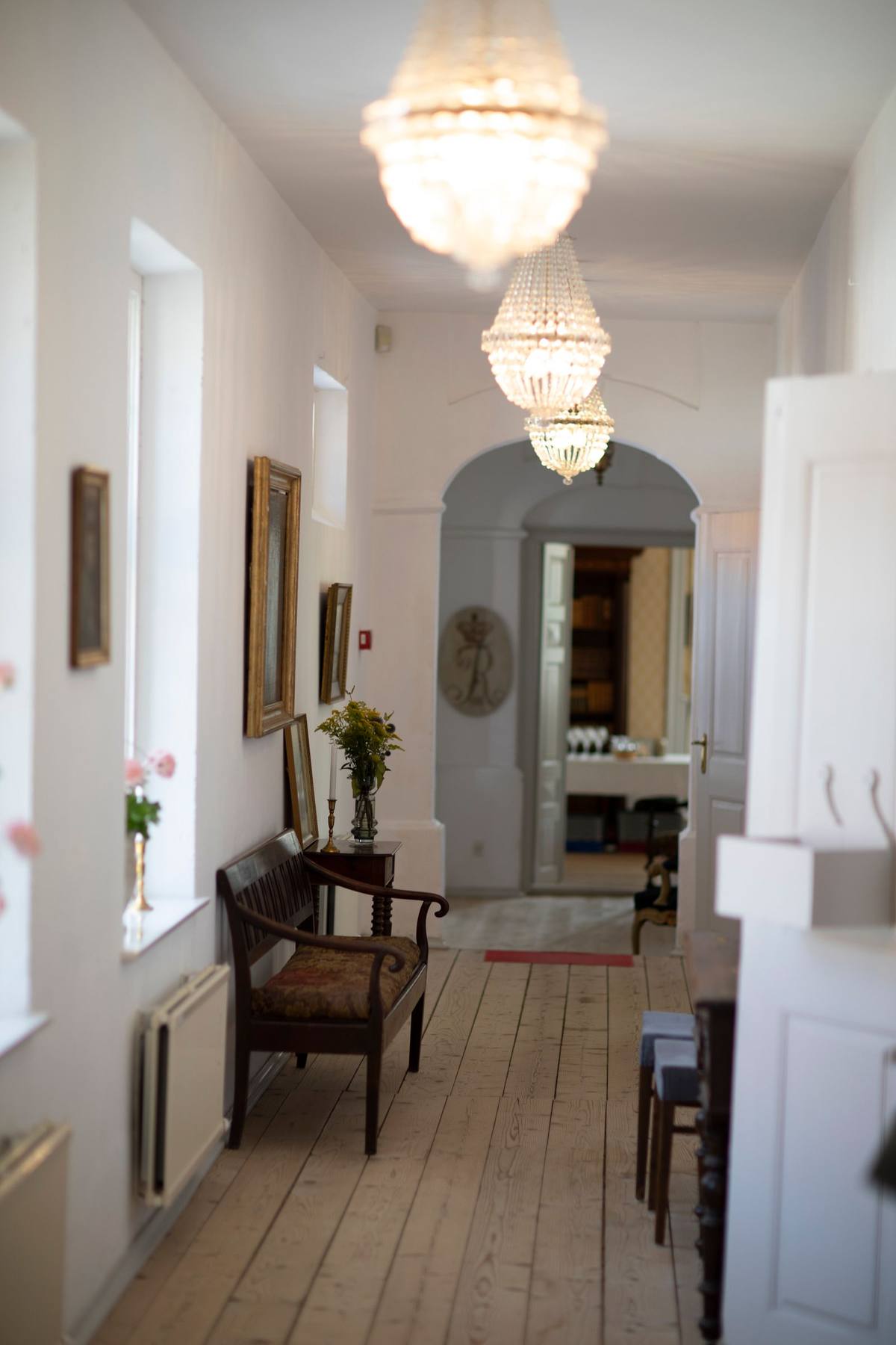 Warm-lit home hallway — the nighttime path between bedroom and bathroom