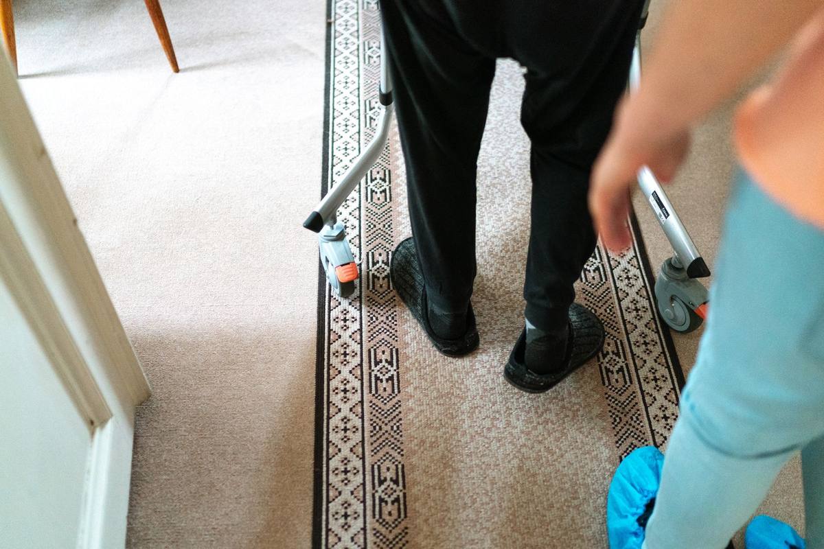 Senior man moving with support on a bright walkway