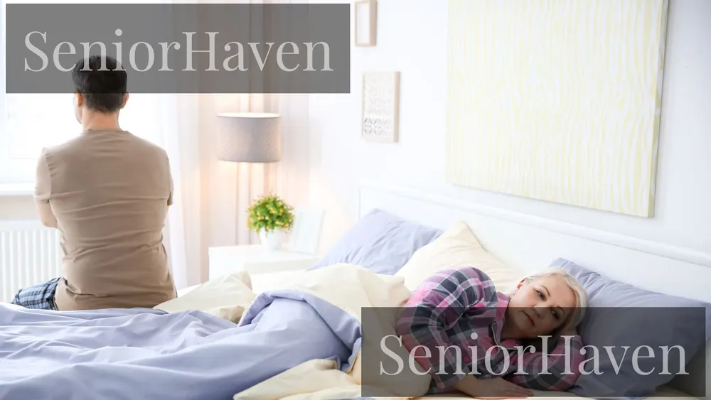 A man sitting upright on one side of a bed while a woman lies flat on the other side